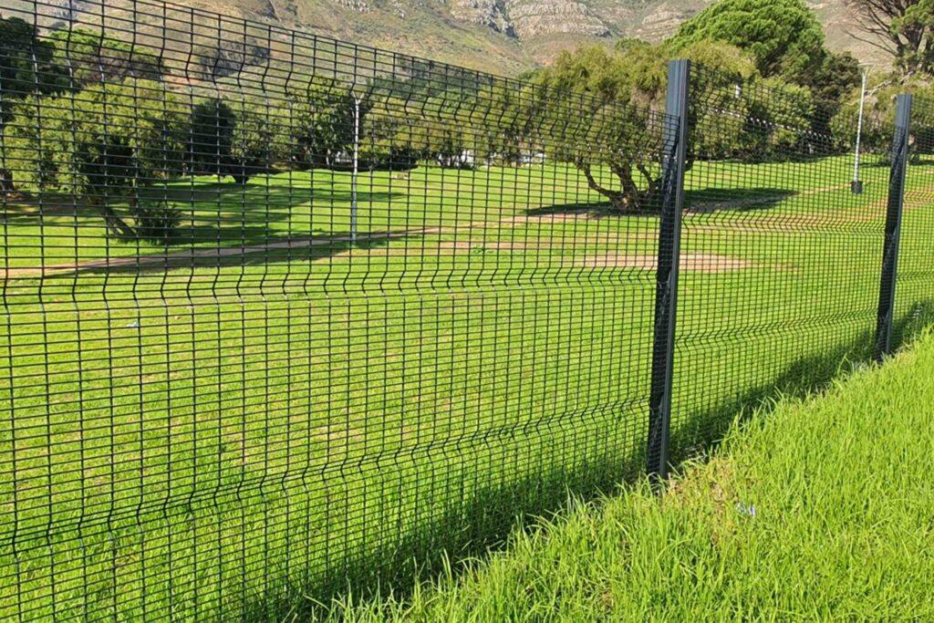 Black welded clear-view mesh fence panels around a lawn