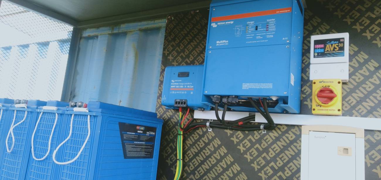 Inverter, solar charge controller and battery bank installed in a plant room