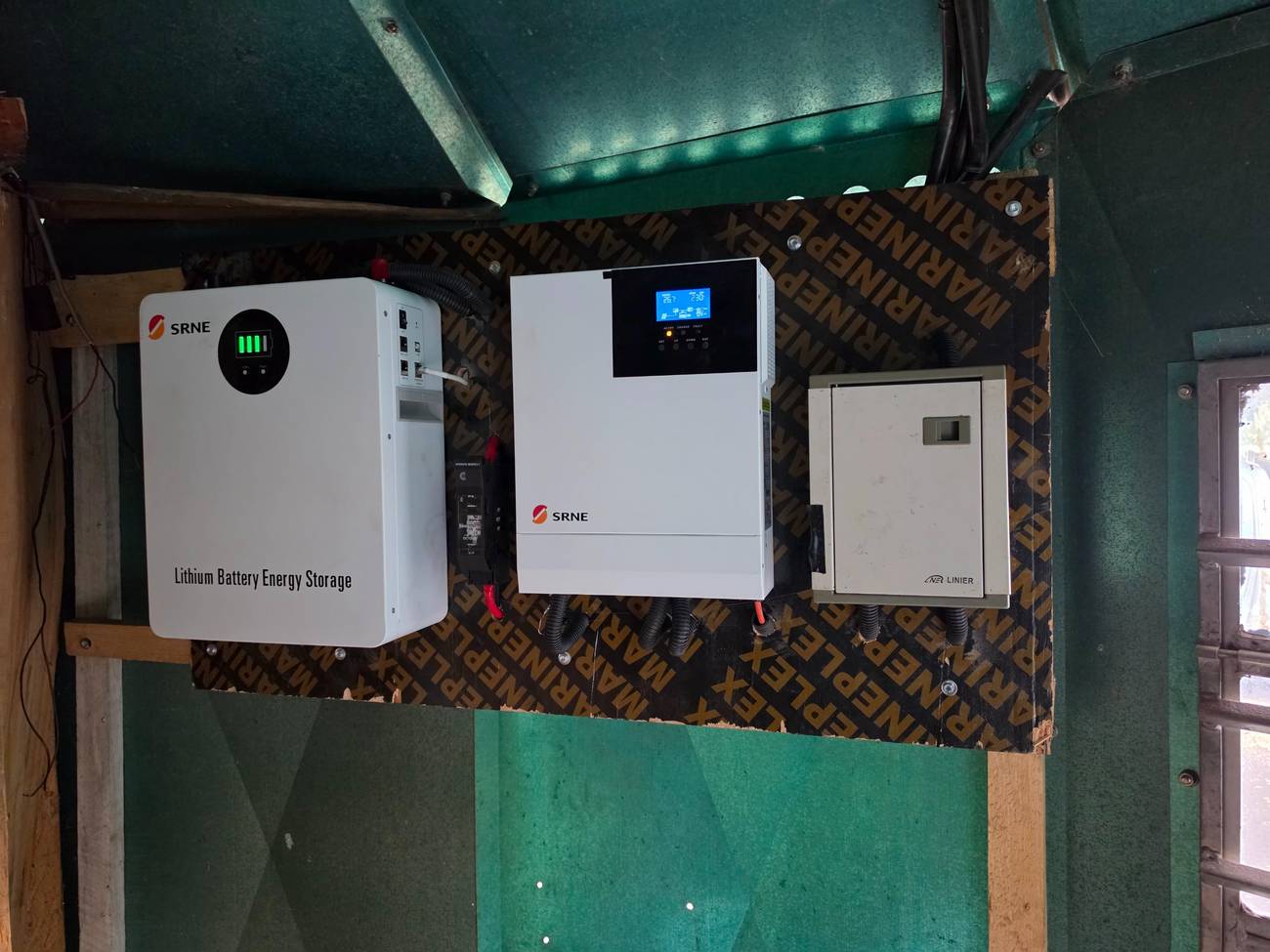 Lithium battery, hybrid inverter and distribution board mounted on a wall panel